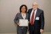 Dr. Nagib Callaos, General Chair, giving Dr. Maritza Placencia_Medina an award certificate in appreciation for her presentation oriented to inter-disciplinary communication entitled: "Evaluation by Competences in a Clinical Environment of a Public University."